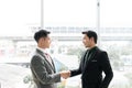 Young asian businessman shakes hands to his partner agrees to cooperate in business. / business concept / cooperate work / Royalty Free Stock Photo