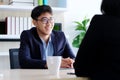 Young asian businessman smiling at business meeting, job interview, in office, business people, office lifestyle concept Royalty Free Stock Photo