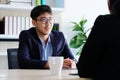 Young asian businessman smiling at business meeting, job interview, in office, business people, office lifestyle concept Royalty Free Stock Photo