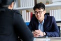 Young asian businessman smiling at business meeting, job interview, in office, business people, office lifestyle concept Royalty Free Stock Photo