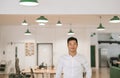 Young Asian businessman smiling confidently while standing in an office Royalty Free Stock Photo
