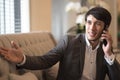 Young Asian businessman in suit speaking on the phone in office. Royalty Free Stock Photo