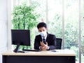 Young Asian businessman pain while using notebook computer in office Royalty Free Stock Photo