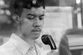 Young Asian businessman using the payphone outdoors Royalty Free Stock Photo