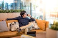 Young Asian businessman using smartphone in living space Royalty Free Stock Photo