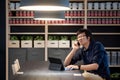 Young Asian businessman using smartphone and tablet in co working space Royalty Free Stock Photo