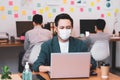Young asian businessman wearing protective mask for covid19 protection corona flu prevent healty ideas concept office background. Royalty Free Stock Photo