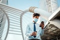 Young Asian Businessman Wearing a Surgical Mask and Using a Smart Phone in City. Healthcare in New Normal Lifestyle Royalty Free Stock Photo