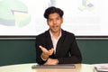 Young asian businessman in white shirt and black suit looking at camera, recording self-presentation video or sharing professional Royalty Free Stock Photo