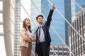 Young Asian businessman and woman standing outdoors pointing out showing business plans sharing and discussing ideas at outdoor Royalty Free Stock Photo