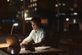 Young Asian businessman working late at night at his desk Royalty Free Stock Photo