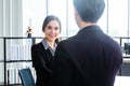 Young Asian Businessperson are standing and talking about financial business concept to agree on trade proposals within the modern Royalty Free Stock Photo