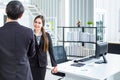 Young Asian Businessperson are standing and talking about financial business concept to agree on trade proposals within the modern Royalty Free Stock Photo