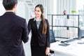 Young Asian Businessperson are standing and talking about financial business concept to agree on trade proposals within the modern Royalty Free Stock Photo