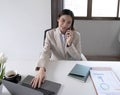 Young asian businesswoman beautiful charming smiling and talking on the mobile phone in the office. Royalty Free Stock Photo