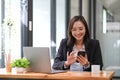 Young asian businesswoman beautiful charming smiling and talking on the mobile phone sitting at the office. Royalty Free Stock Photo