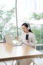 Young asian businesswoman beautiful charming smiling and using on mobile phone in the office Royalty Free Stock Photo