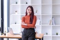 Young Asian businesswoman cheerful mature standing In the office room Royalty Free Stock Photo