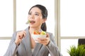 Young asian businesswoman enjoying a healthy salad Royalty Free Stock Photo