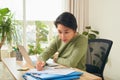 Young Asian businesswoman focusing on her documents