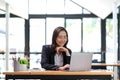 Young Asian businesswoman is happy to work at the modern office using a tablet. Royalty Free Stock Photo