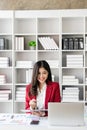 Young Asian businesswoman is happy to work at the modern office using a tablet and laptop Royalty Free Stock Photo