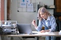 Young Asian businesswoman is happy to work at the modern office using a tablet. Royalty Free Stock Photo