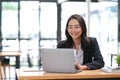 Young Asian businesswoman is happy to work at the modern office using a tablet. Royalty Free Stock Photo
