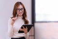 Young Asian businesswoman holding a tablet working In the office room Royalty Free Stock Photo