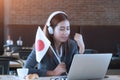 Young asian businesswoman listening online match, cheer Japan te