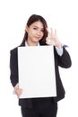 Young Asian businesswoman show OK with vertical blank sign Royalty Free Stock Photo