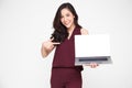 Young Asian businesswoman showing a laptop over white background and pointing finger to white screen of notebook with copy space