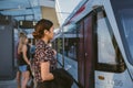 Young Asian businesswoman boarding a train during her work commute