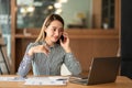 A young Asian businesswoman stands in front of her desk holding a smirked tablet. money business idea Royalty Free Stock Photo