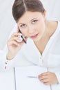 Young asian businesswoman talking on the phone, seen in top view. Business, office, school and education concept. Royalty Free Stock Photo