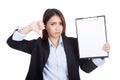 Young Asian businesswoman thumbs down with blank clipboard Royalty Free Stock Photo