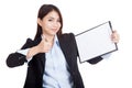 Young Asian businesswoman thumbs up with blank clipboard Royalty Free Stock Photo