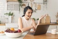 Young Asian businesswoman using computer laptop talking for video call conference meeting. work from home concept Royalty Free Stock Photo