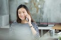 Young Asian businesswoman using smartphone to interact with customers in the office. Royalty Free Stock Photo