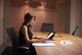 Young Asian businesswoman working alone late in an office