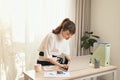 Young Asian businesswoman working with laptop and standing behind the desk at home Royalty Free Stock Photo