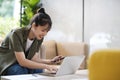 Young asian businesswoman working at office using mobile phone.. Royalty Free Stock Photo