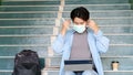 Young asian campus student man wearing protection mask while sitting in campus, coronavirus prevention in university, social Royalty Free Stock Photo