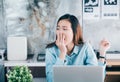 Young asian casual businesswoman yawn in front of laptop compute