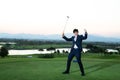 Young Asian CEO Businessman wearing suite playing golf at the golf course. Portrait of Asian businessman joying to success