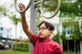 Young asian children hang on the monkey bar. To exercise at outdoor playground in the neighbourhood