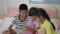 Young asian children`s grop taking selfie with smartphone at bedroom.