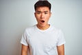 Young asian chinese man wearing t-shirt standing over isolated white background afraid and shocked with surprise and amazed Royalty Free Stock Photo