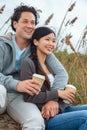 Asian Man Woman Romantic Couple Drinking Takeout Coffee on Beach Royalty Free Stock Photo