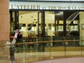 A young Asian Chinese shopper wearing a face mask outside a luxury watch boutique store at Ion Orchard shopping mall, Singapore Royalty Free Stock Photo